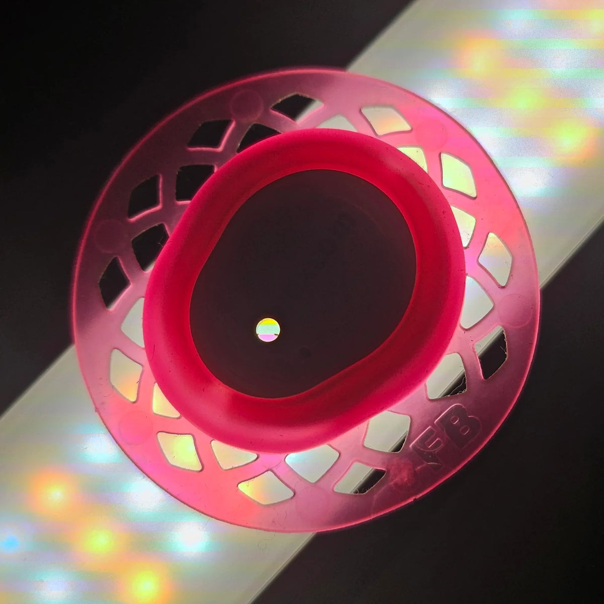 Pink Infiniflex CGM sensor cover guard with decorative cutout design